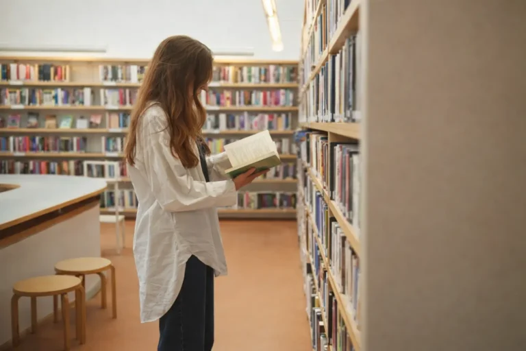 person reading a book in a library representing structured addiction knowledge hub and conceptual understanding of recovery