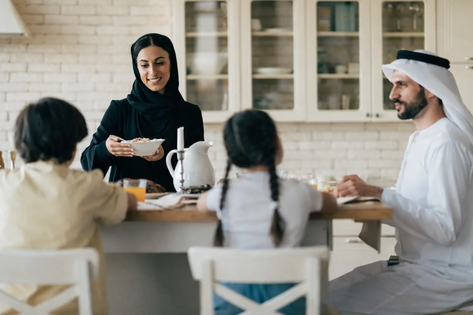 Arab family sharing a meal together at home representing family support and stability during recovery from addiction