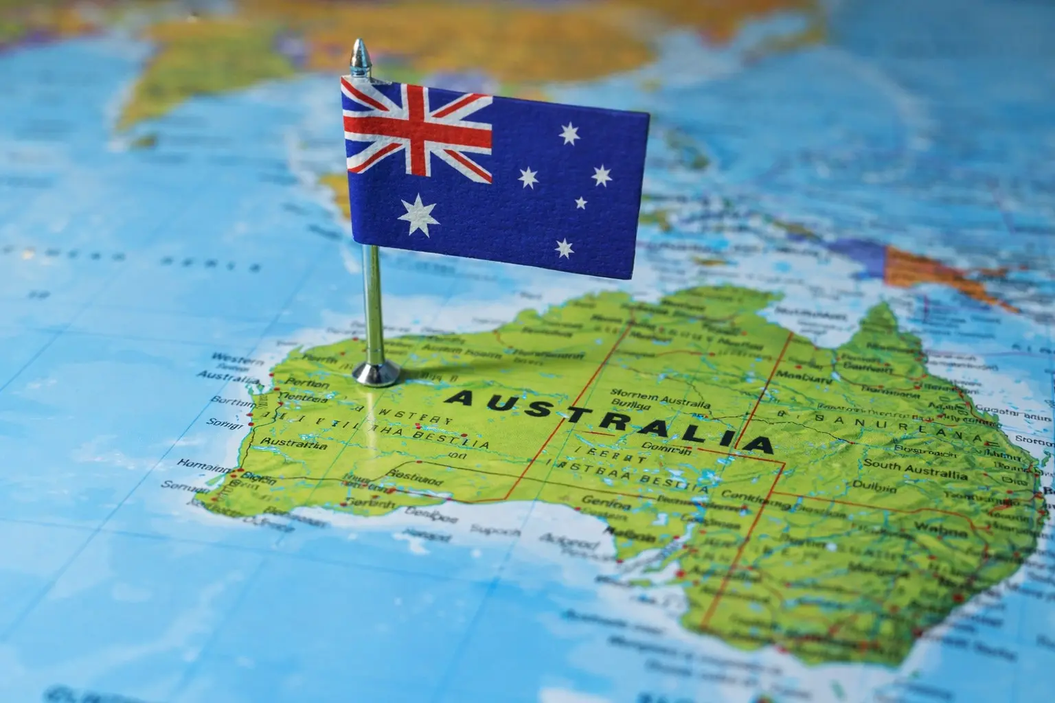Australian flag pinned on a map of Australia, highlighting geographic location relevant to domestic and overseas addiction treatment decisions.