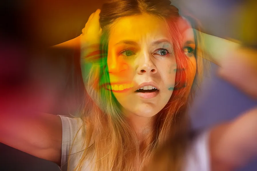 Woman experiencing intense mood swings, with overlapping emotional expressions symbolizing bipolar disorder
