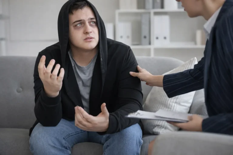 Individual in a therapy session speaking with a clinician who offers supportive contact, representing structured inpatient addiction treatment in Australia.