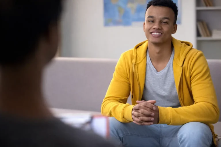 Individual seated in a counseling setting facing a therapist, representing structured residential addiction treatment and recovery duration planning in Australia.